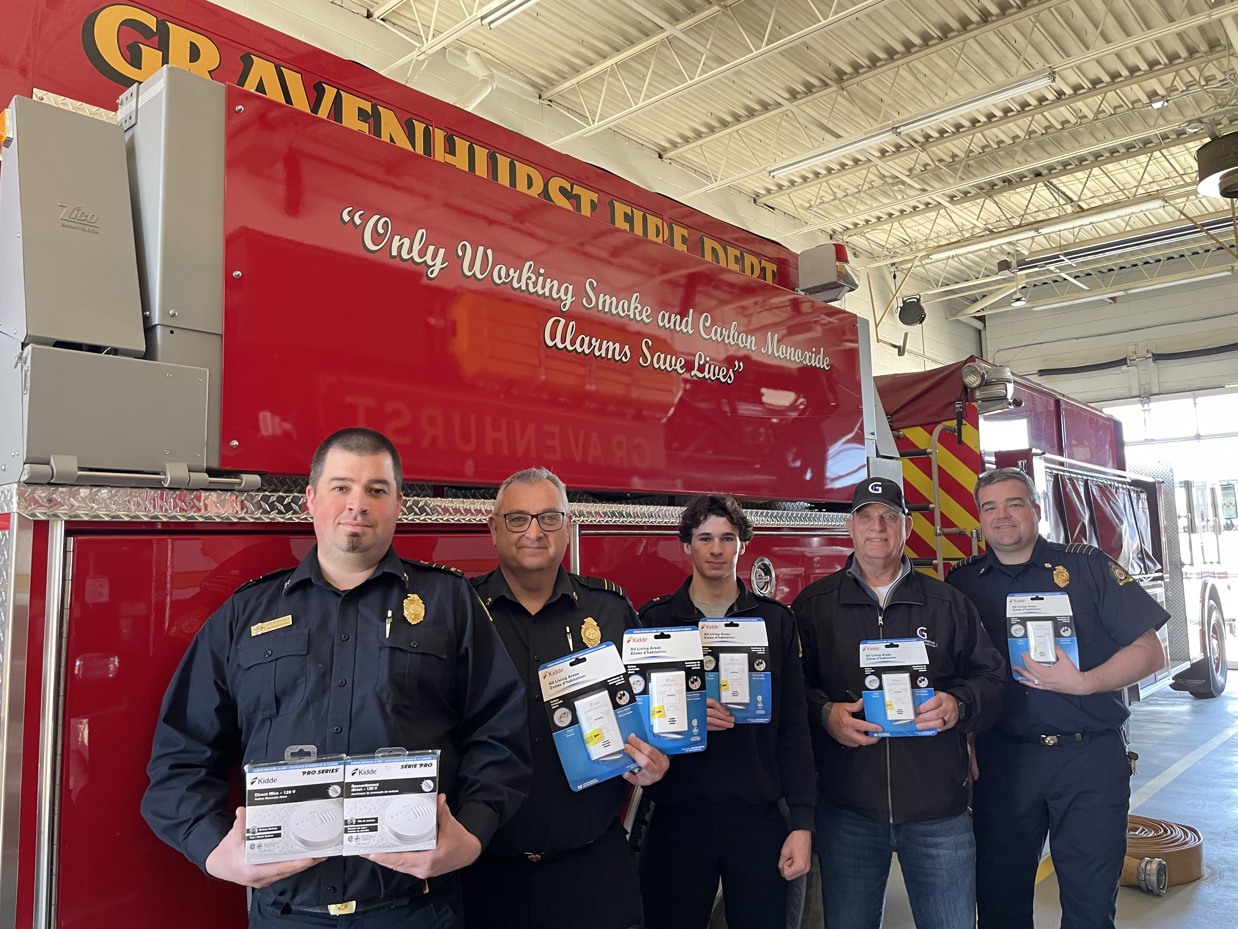 Firefighters with CO alarm donation