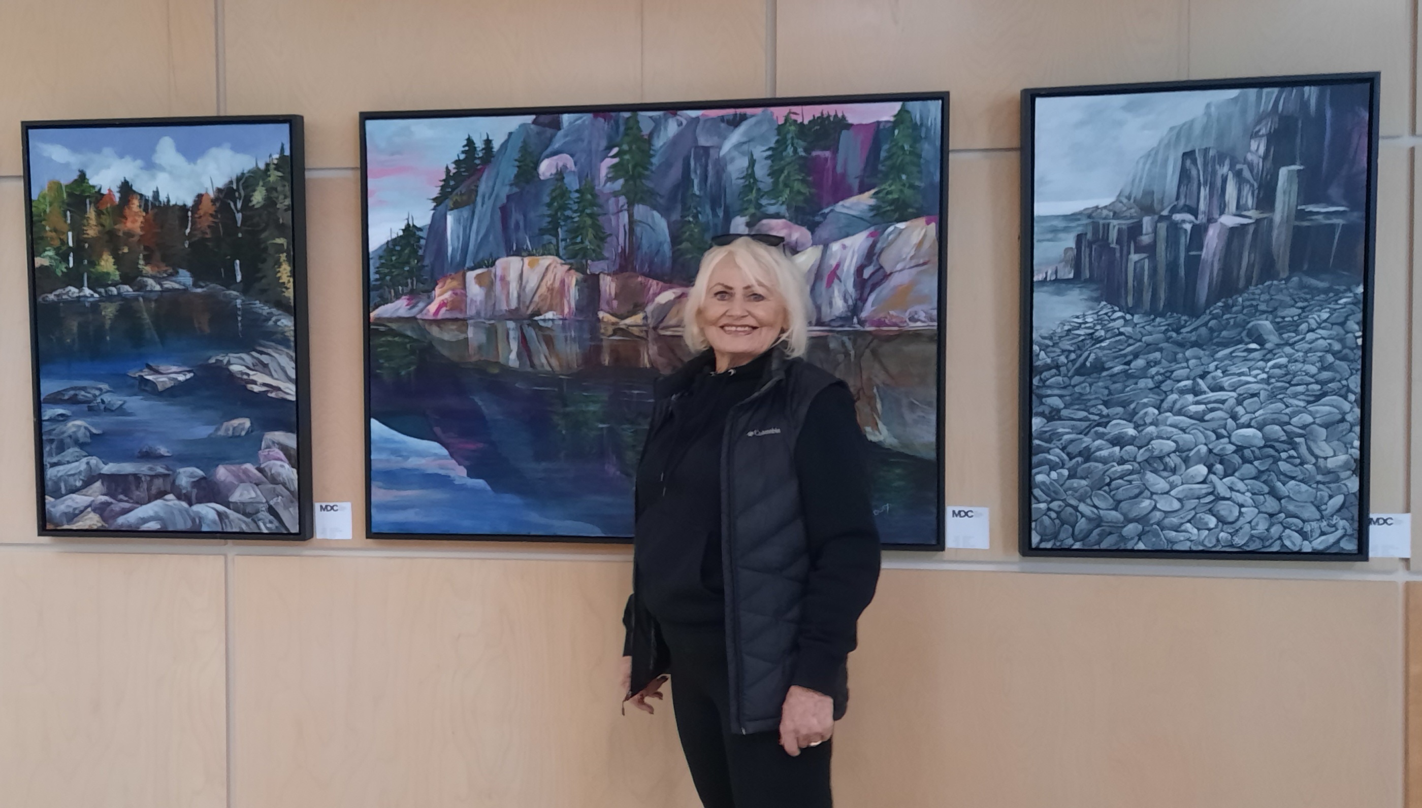 Linda Gidora in front of her artwork